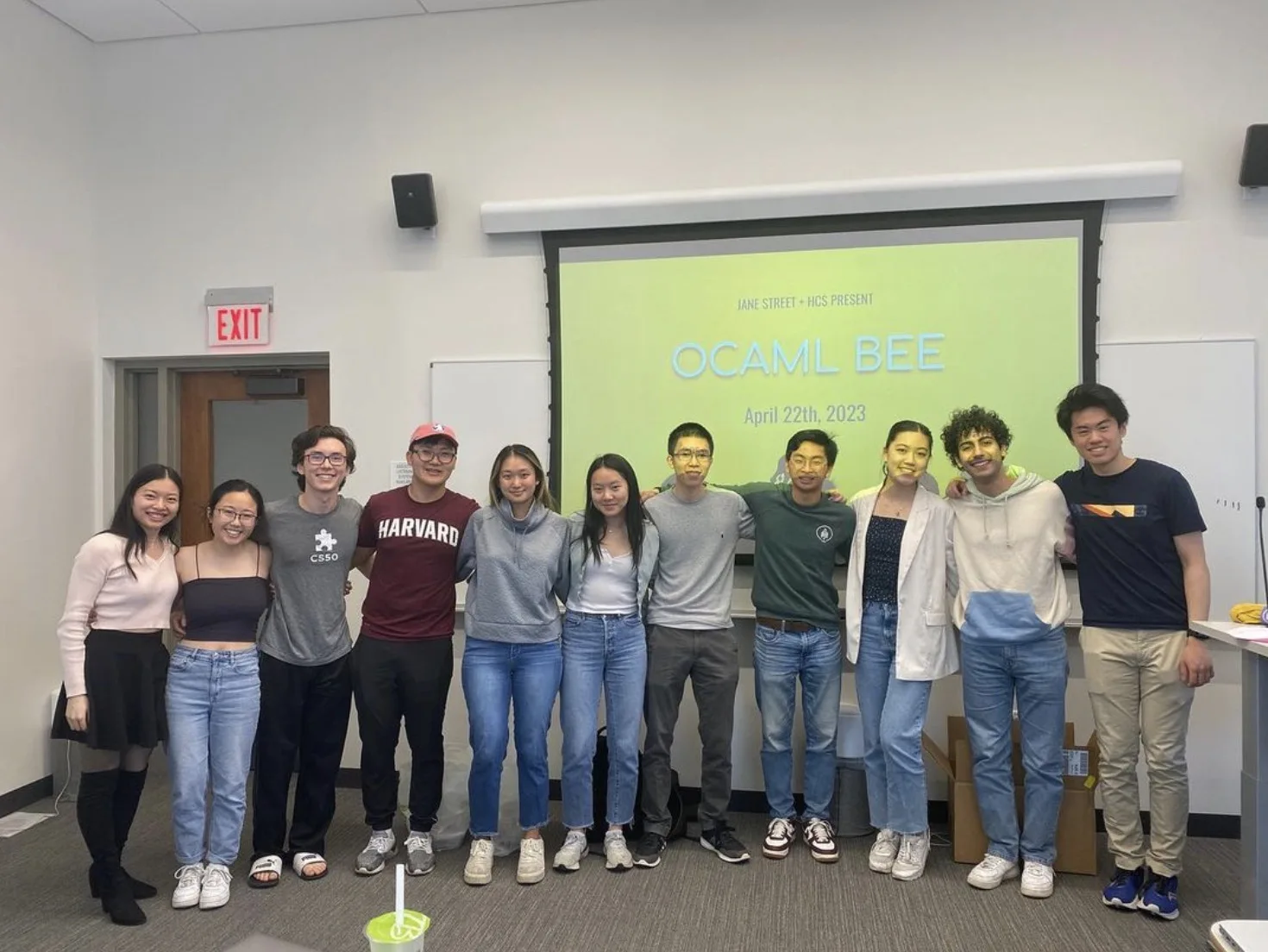 Students posing in front of an OCaml Bee presentation