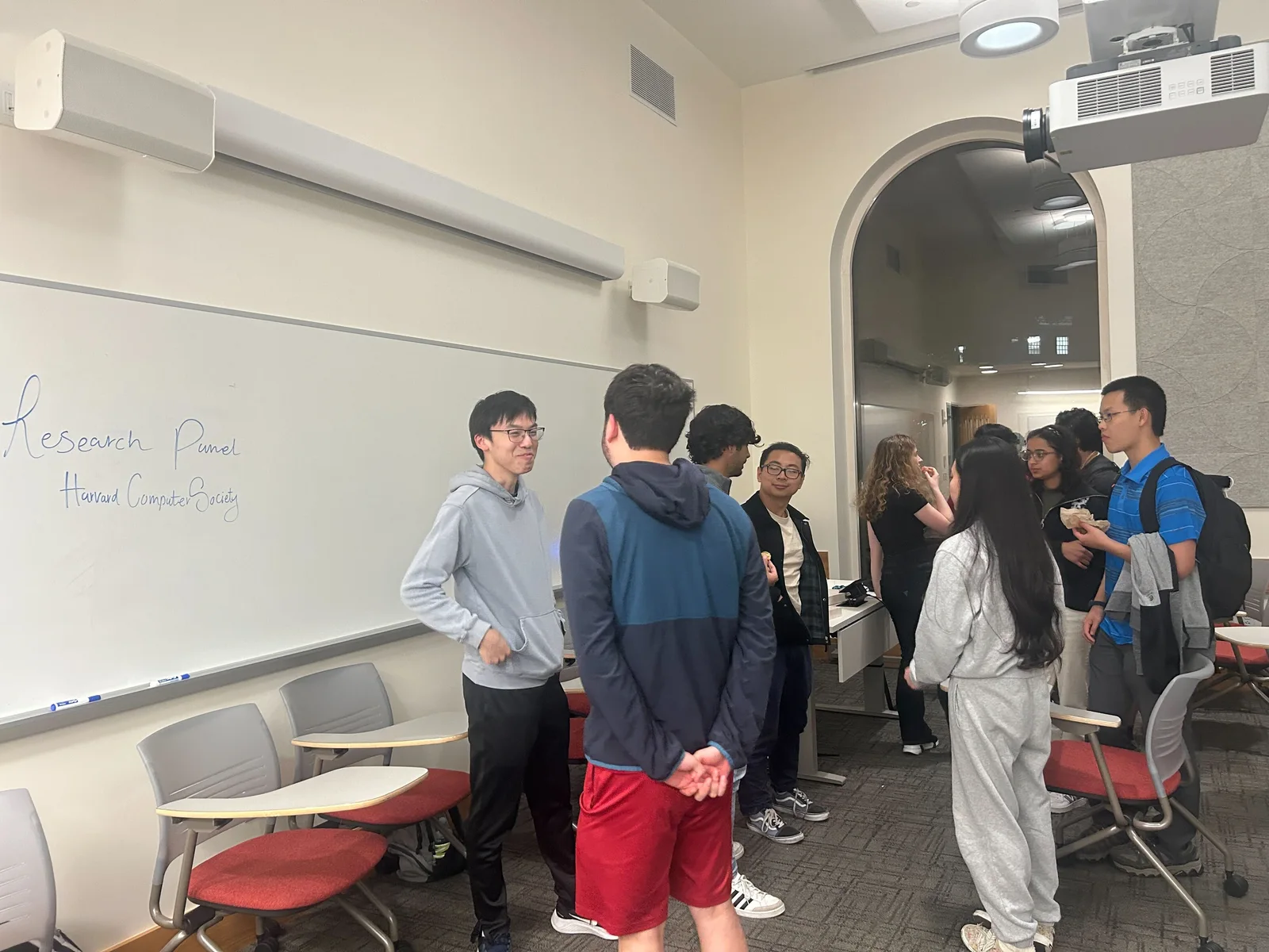 Students and speakers talking after the HCS research panel